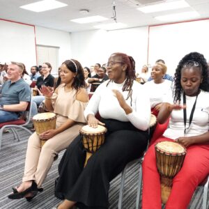 Employees laughing together during a teambuilding exercise.