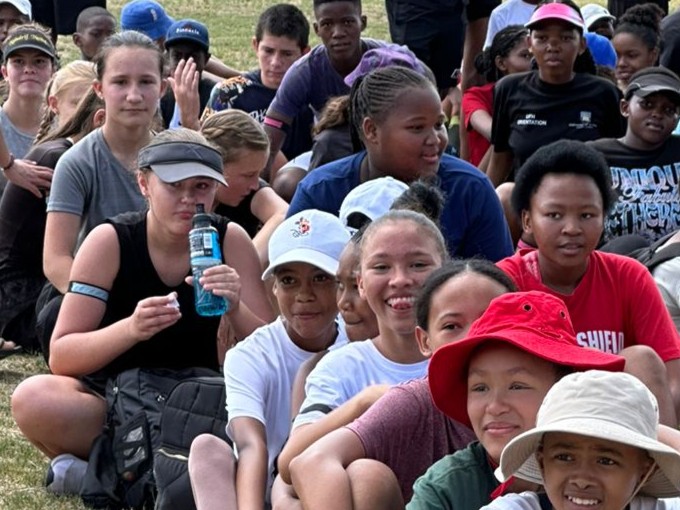 Grade 7 students participating in a fun and engaging teambuilding activity, working together to develop leadership, teamwork, and problem-solving skills in an outdoor setting.