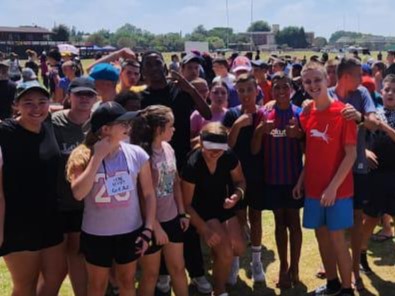 Grade 7 students participating in a fun and engaging teambuilding activity, working together to develop leadership, teamwork, and problem-solving skills in an outdoor setting.